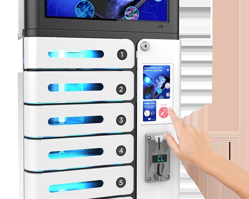 A hand entering a code at the control panel of a wall-mounted charging locker