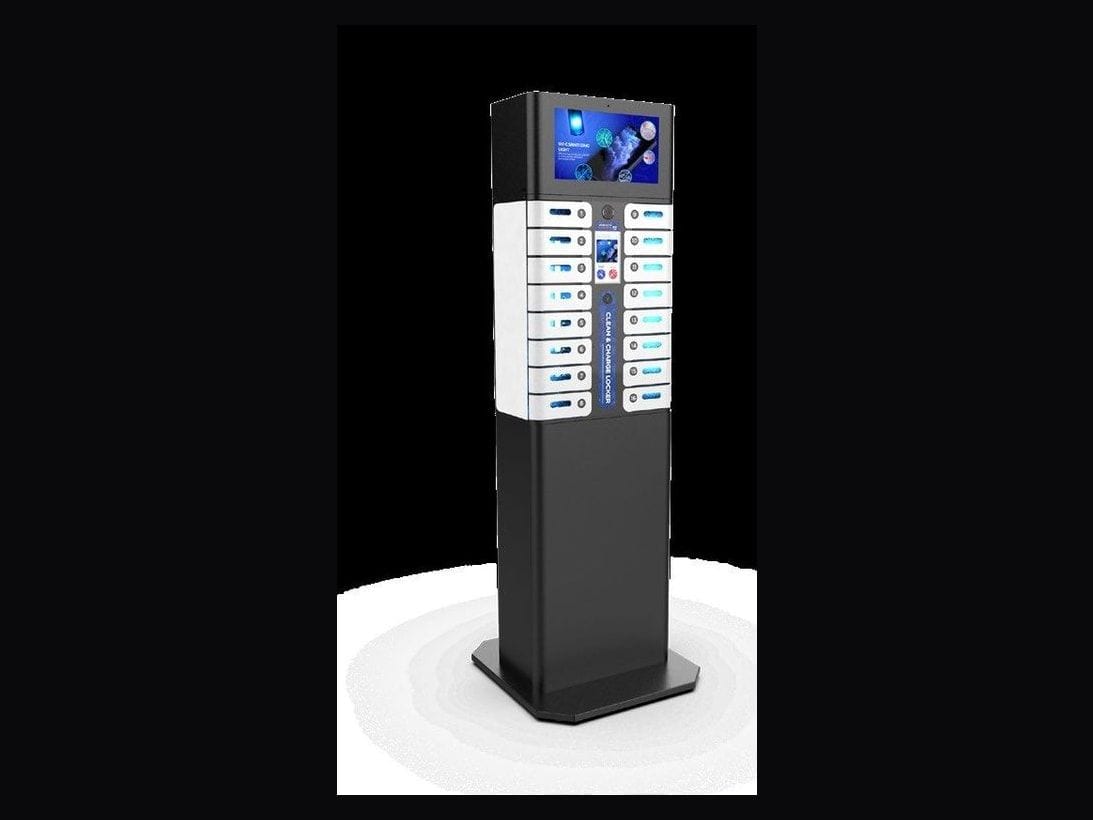 A tall slim charging tower with a column of illuminated bays and a screen at the top