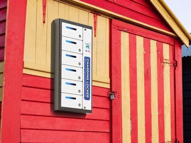 A slim charging locker mounted on the outside wall of a beachfront building